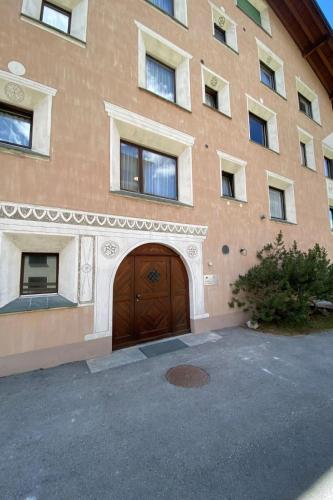 a large building with a large wooden door at Apartment Wohnung Curtins by Interhome in Pontresina