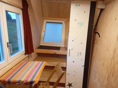 a tiny house with a climbing wall and a window at Holiday Home Tiny Hause by Interhome in St. Gallen