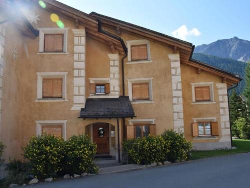 a house with a mountain in the background at Apartment Culaischem 2 by Interhome in Zuoz