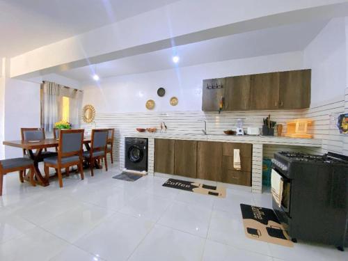 a kitchen and dining room with a table and a stove at Njiwa suites 1034 in Mombasa