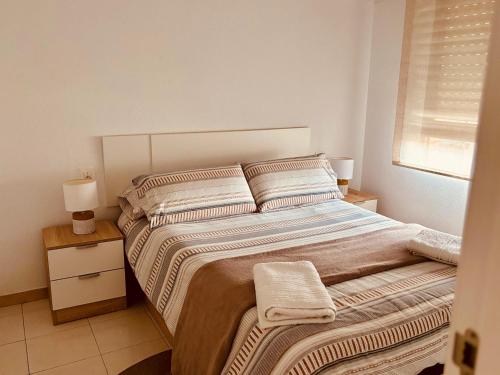 a bedroom with a large bed with two pillows at Costa Flow Apto Benicasim in Benicàssim