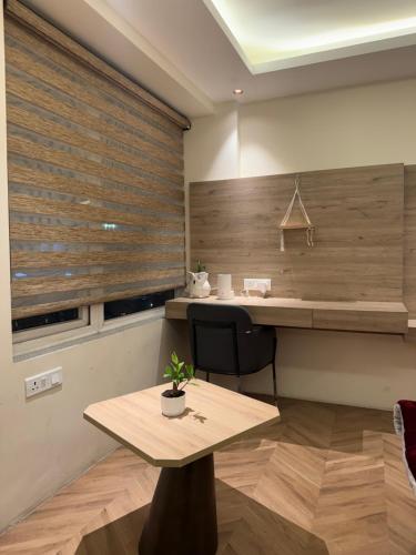 a kitchen with a wooden counter and a wooden table at Luna Stays in Greater Noida