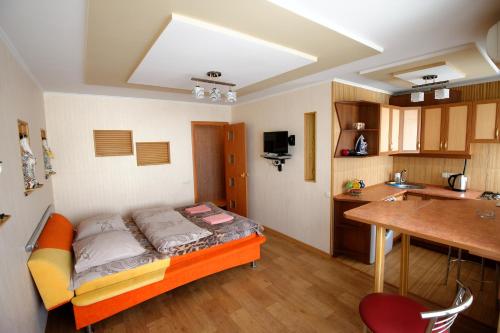 a small room with a bed and a kitchen at 2 room Apartment above Verona Cafe Very Center in Kherson