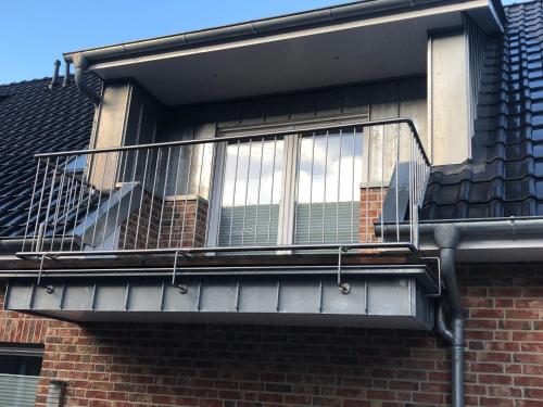 a balcony on the side of a brick building at Apartment Heidestrauch by Interhome in Thülsfeld