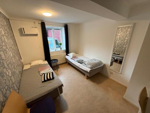 a small room with a bed and a couch at Bakgården Mariestad in Mariestad
