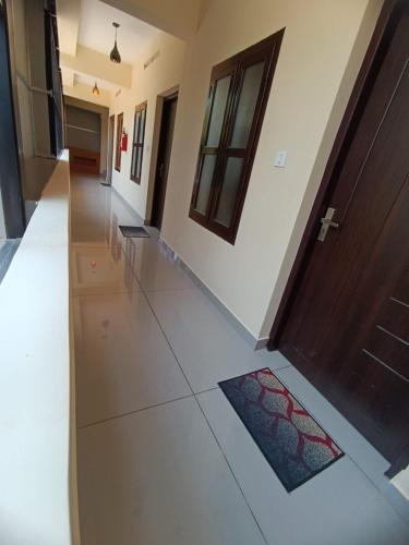 a hallway with a door and a tile floor at MADAVATH RESIDENCY in Kenichira