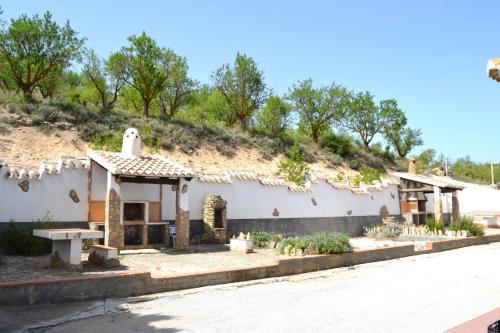 a small white house with a hill in the background at Casas rurales la Codorniz in Almaciles