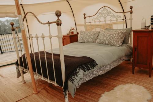 a bedroom with a bed with a metal frame at Kay Bell in Masterton