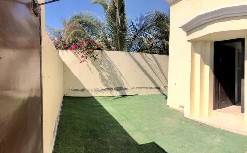 a hallway of a house with a green lawn at Masirah oyster in Ḩilf