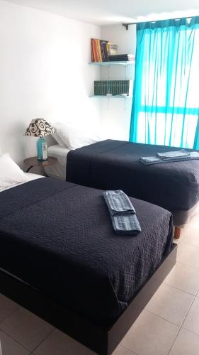 two beds sitting next to each other in a bedroom at Aeropuerto Pantitlán CDMX in Mexico City