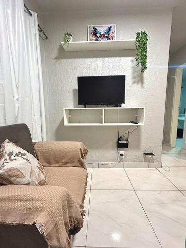 a living room with a flat screen tv on a wall at Apartamento CONFORT 2Q in Rio Branco