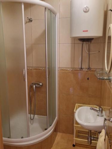 a bathroom with a shower and a sink at Apartments Biser in Podgora