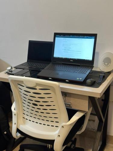 a laptop computer sitting on top of a desk at AuraStays in Dargai