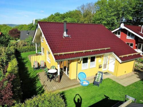 an overhead view of a yellow house with a deck at Holiday Home Lea by Interhome in Bremke