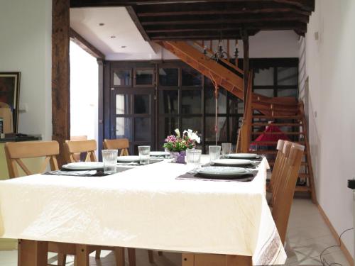 a dining room table with a white table cloth and chairs at The Red Konak in Veliko Tŭrnovo