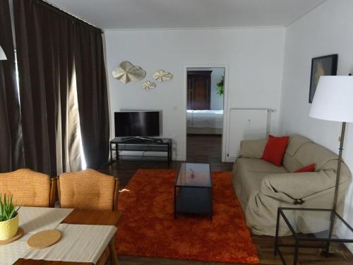 a living room with a couch and a table at Apartment Rheintalblick 2 by Interhome in Linz am Rhein