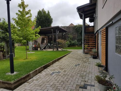 a garden with a brick walkway next to a building at Apartment Mia by Interhome in Fritzlar