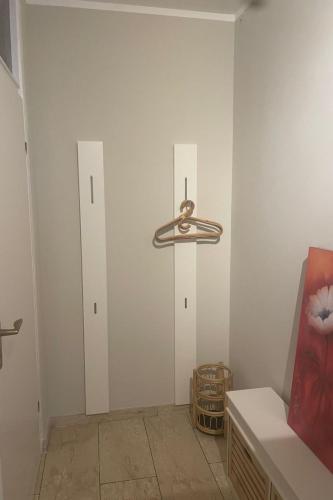 a room with white walls and a light fixture on the wall at Apartment Becker by Interhome in Bad Neuenahr-Ahrweiler