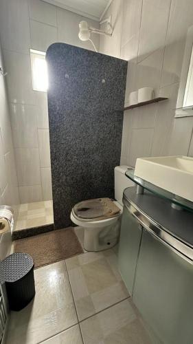 a small bathroom with a toilet and a sink at Suites da Bela 03 Caparaó in Caparaó Velho