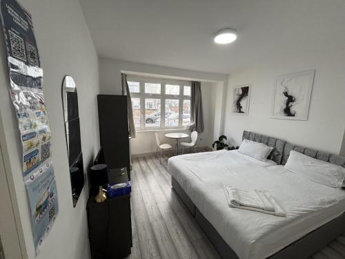 a small bedroom with a bed and a window at Streatham Rooms in London