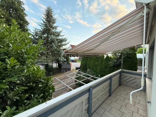 a porch with awning on a house with a fence at Offingener Ferienhaus & Monteurhaus in Offingen