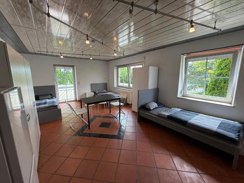 a room with two beds and a desk in it at Offingener Ferienhaus & Monteurhaus in Offingen