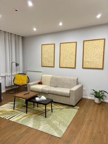 a living room with a couch and a table at AB apartment Pistoia in Pistoia