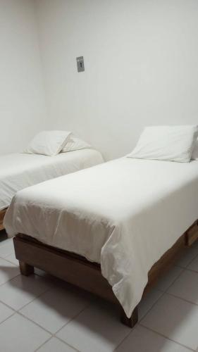 two beds sitting next to each other in a bedroom at Orizaba Suites in Río Blanco