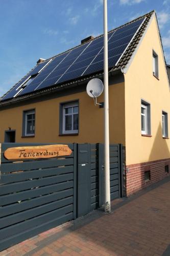 a house with solar panels on the roof at Apartment Fewo Wilhelm by Interhome in Scholis
