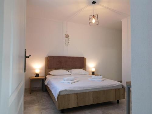 a bedroom with a large bed with two lamps at Casa Giulia in Vama Veche