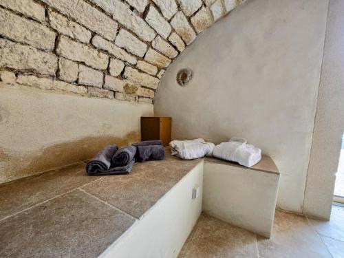 two pairs of shoes sitting on a counter next to a brick wall at Gite De L'Aeti - Bail Partner in Chablis