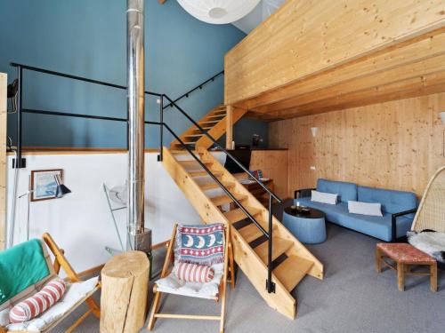 a living room with a staircase and a couch at Apartment Spiegl by Interhome in Waizacker