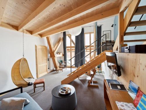 a living room with wooden ceilings and a staircase at Apartment Spiegl by Interhome in Waizacker