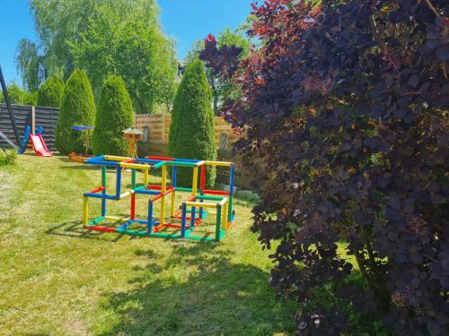 a colorful playground in a yard next to a bush at Apartment Lusen by Interhome in Frauenau