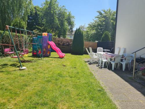 a backyard with a playground with a table and chairs at Apartment Lusen by Interhome in Frauenau