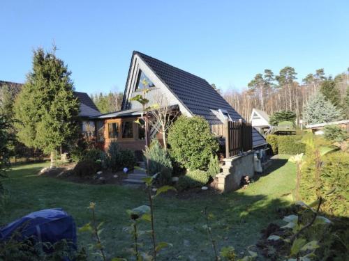 a house in a yard with a yard at Holiday Home Eifelwaldhäuschen by Interhome in Blankenheim