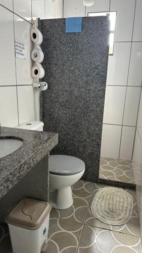 a bathroom with a toilet and a sink at Suites da Bela 05 Caparaó in Caparaó Velho