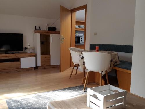 a living room with a table and chairs and a television at Apartment in Berghäuser by Interhome in Grafenwiesen