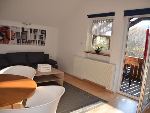 a living room with a table and a couch at Apartment in Berghäuser by Interhome in Grafenwiesen