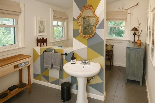 a bathroom with a sink and a mirror at Gingerbird Art Suite in Laurel
