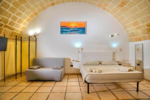 a bedroom with a bed and a couch at History Station in Brindisi