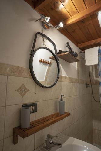 a bathroom with a mirror and a sink at History Station in Brindisi