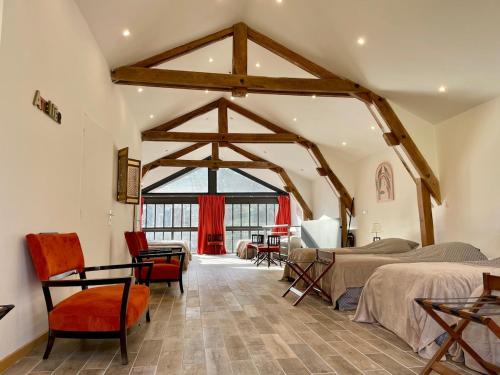 a bedroom with two beds and a large window at La Sorga - gîte 12 personnes in Blesle