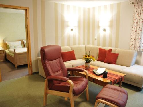 a living room with a couch and a table at Apartment Wiesengrund by Interhome in Neuhaus am Rennweg