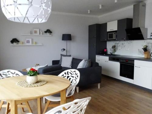 a living room with a table and a couch at Apartment Wünnowblick by Interhome in Röbel
