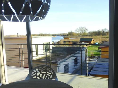 a view from a balcony with a table and a lamp at Apartment Wünnowblick by Interhome in Röbel