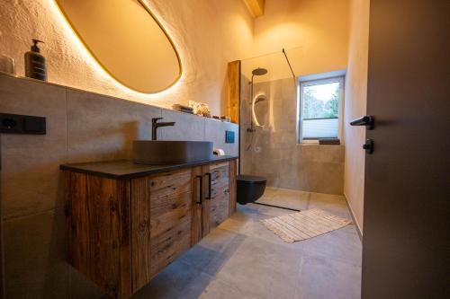 a bathroom with a sink and a mirror at Bomwäldele 89 in Bichlbach