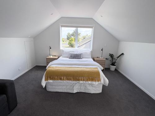 a bedroom with a large bed and a window at STUDIO42 in Papakura