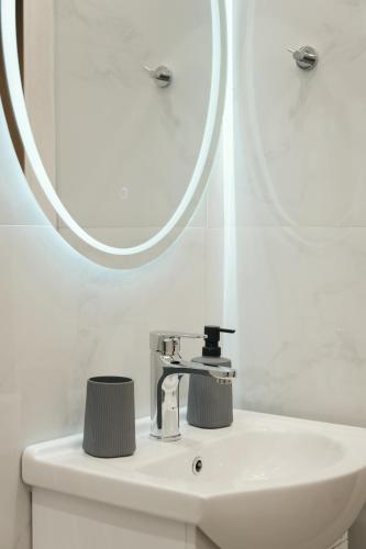 a bathroom with a sink and a mirror at Rhodes Central Apartment in Rhodes Town