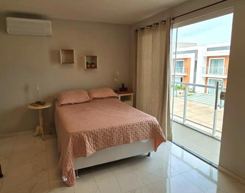a bedroom with a bed and a sliding glass door at SaltBeach Salinópolis Salt Reserve in Salinópolis